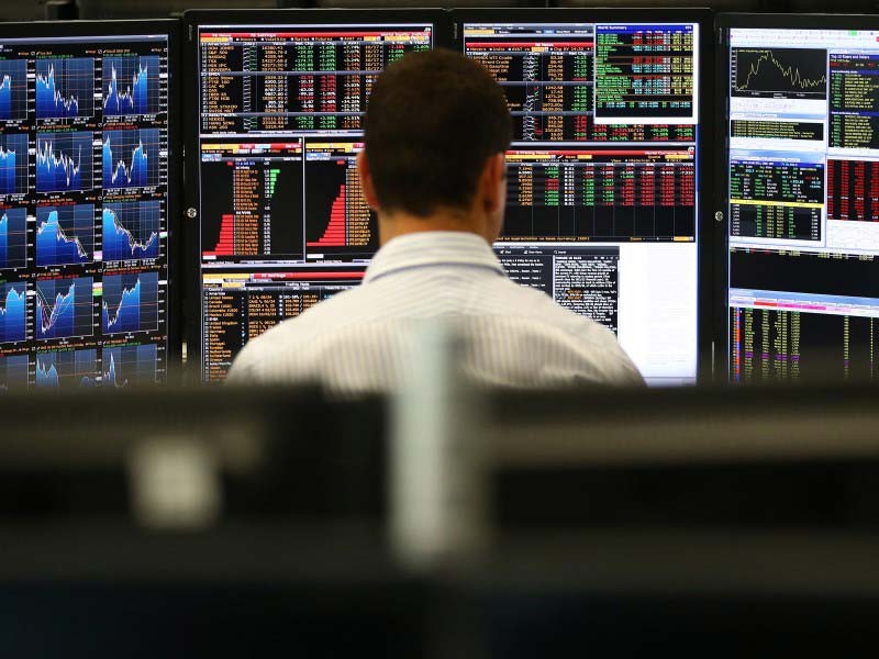 behind view of a man studying APAC REIT capital records on computer.
