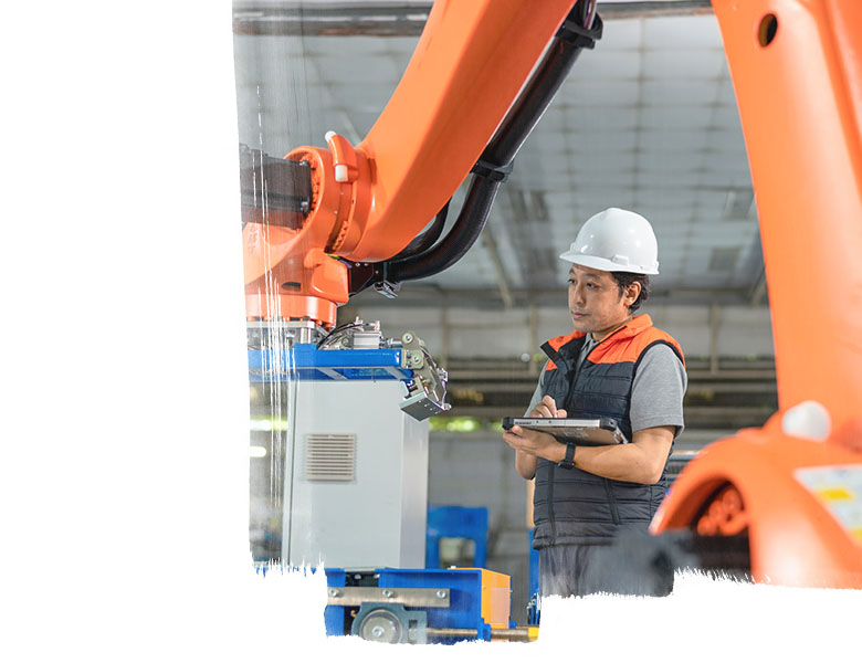 Employee noting down the readings from the machine in the factory