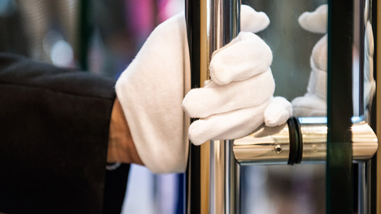Waiter opening the glass door