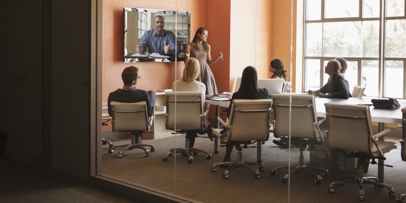 Employees discussing a strategy in a meeting room inside JLL office