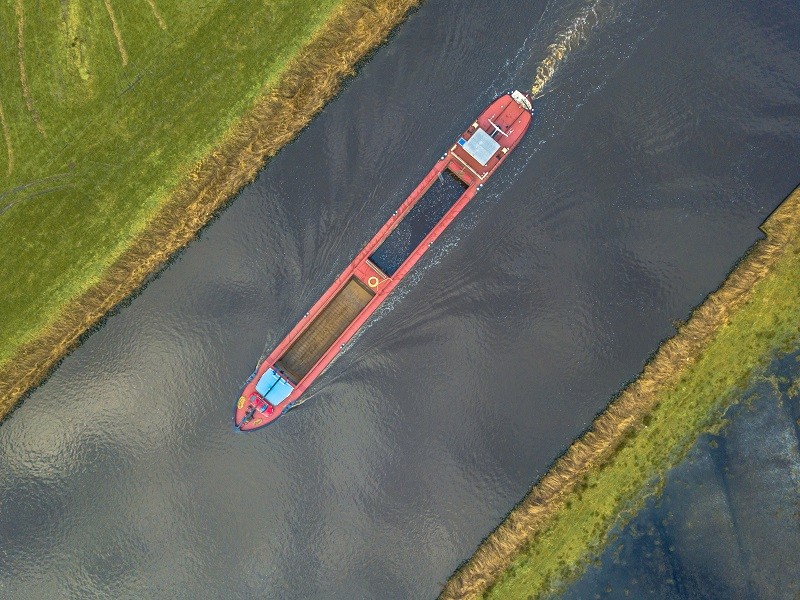 Top down view on inland cargo ship in dutch canal