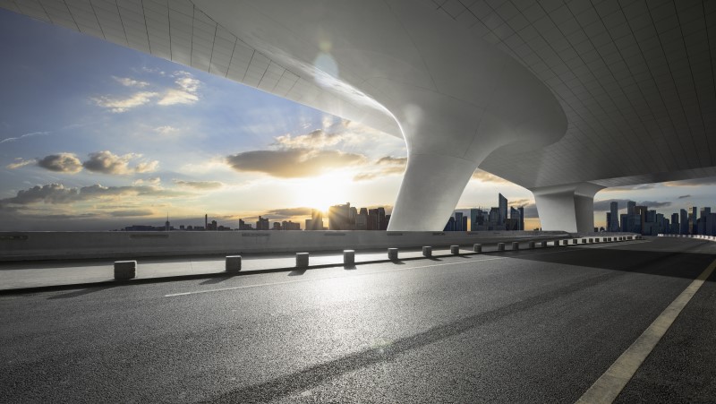 Low angle view from a road of a city skyline 