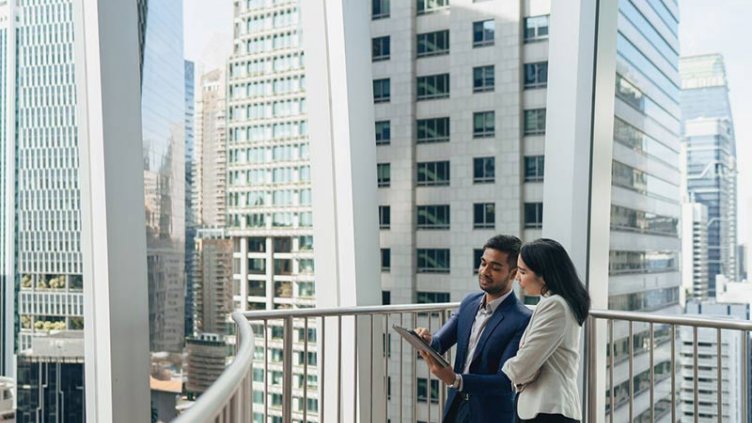 Men and women standing at balcony