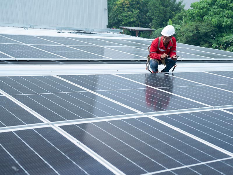 Maintenance engineer inspecting solar panels