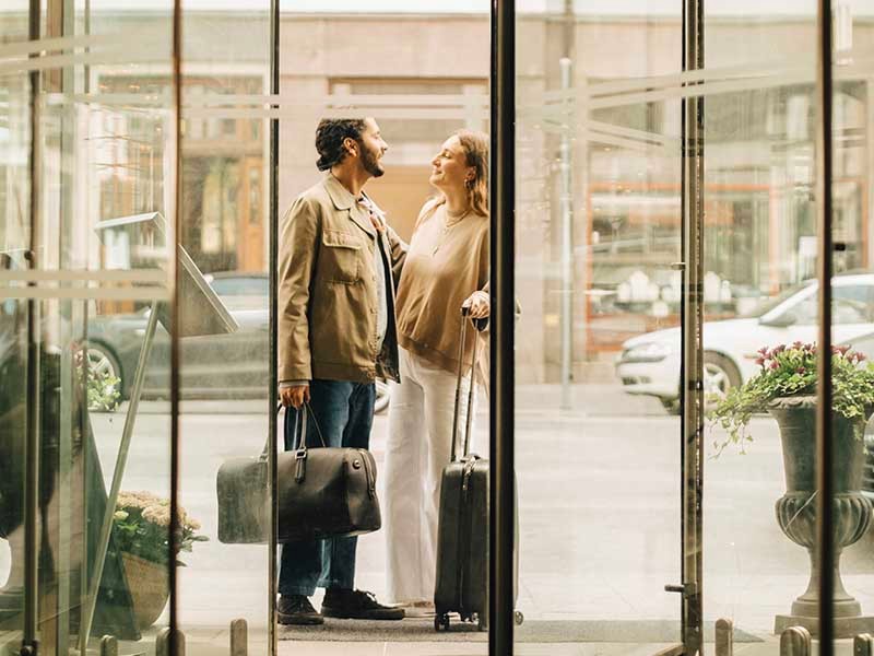 A man women holding bags and looking