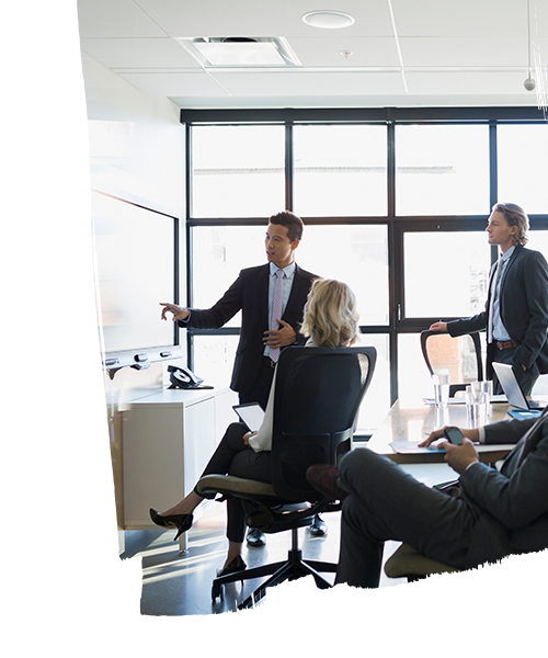 Employees having a meeting inside the meeting room in the real estate office